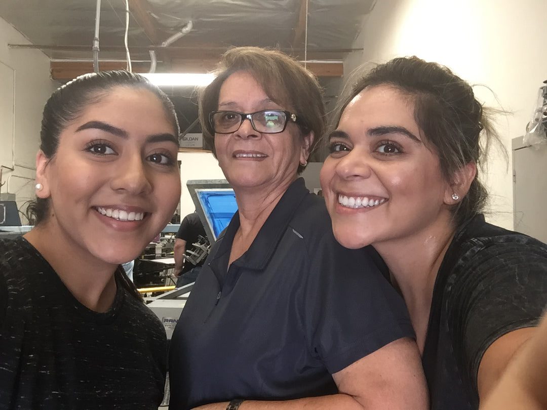 A picture of three women smiling and taking a selfie
